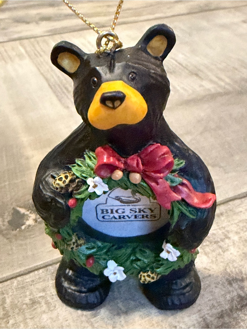 Big Sky Carvers Black Bear Christmas ornament with Green Wreath Frame.